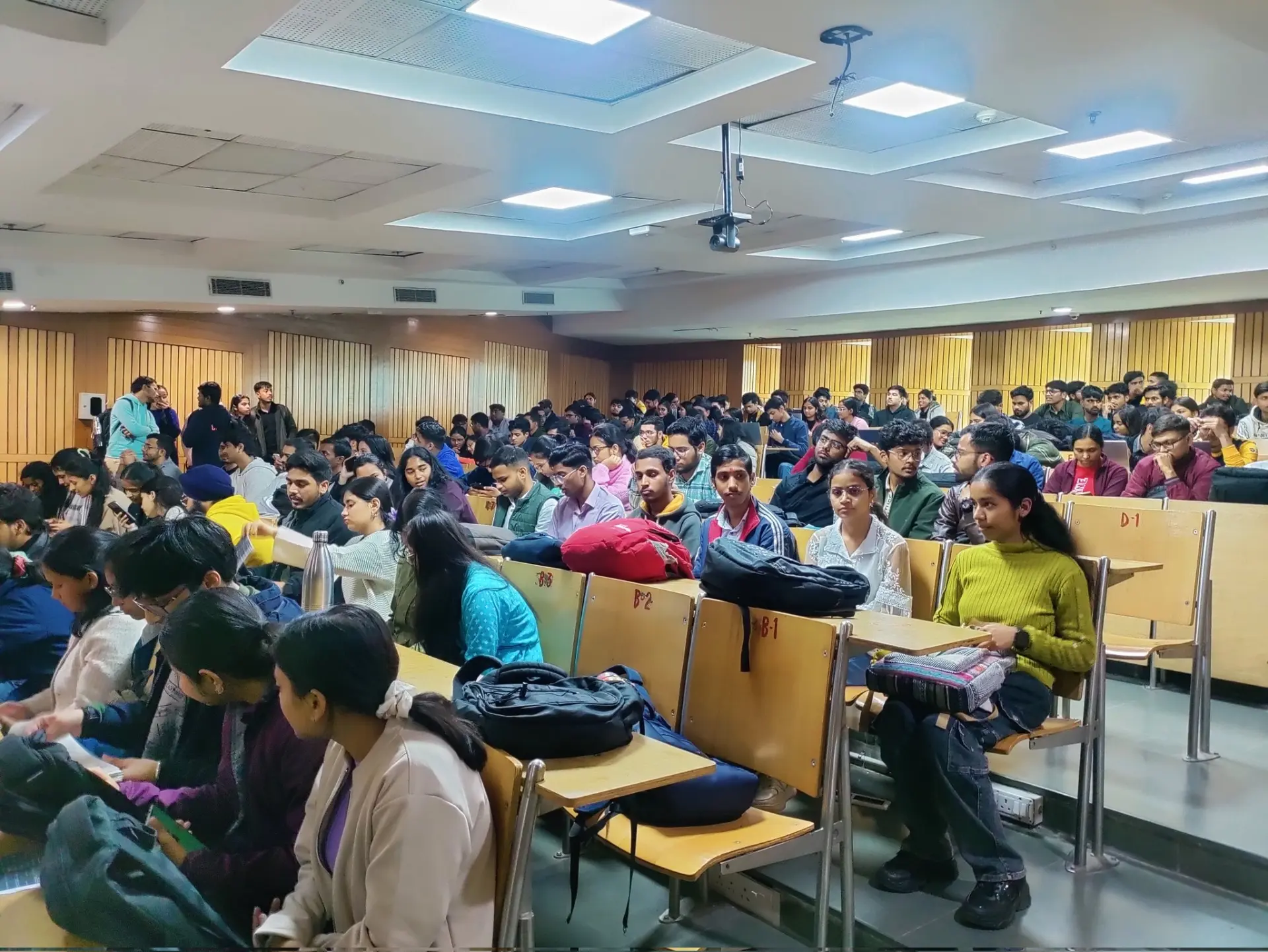 Students filling a university lecture hall during a campus session